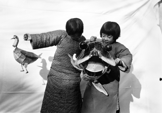 Children with a paper toy and kite from a carnival. 